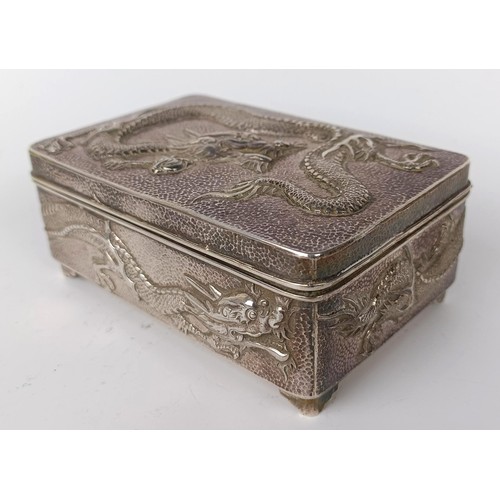 1010 - A Chinese silver coloured metal rectangular box, decorated a dragon, 12 cm wide