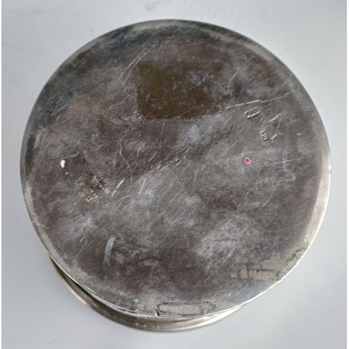 1011 - A Chinese silver coloured metal box, decorated a  dragon, 10 cm diameter