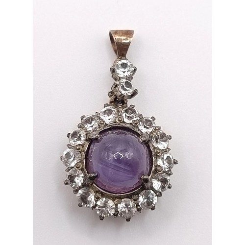 650 - An amethyst and white stone pendant