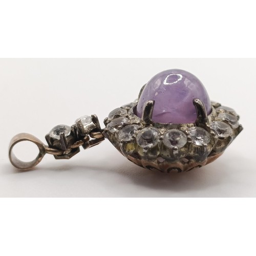 650 - An amethyst and white stone pendant