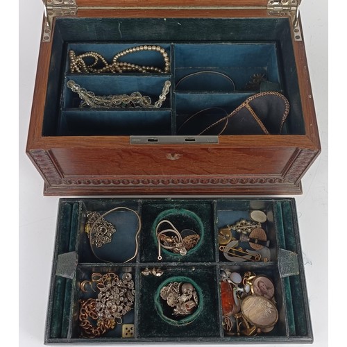 652 - A paste set brooch, a gold plated bracelet, and assorted other costume jewellery, in an oak jeweller...