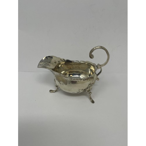 223 - A George III silver Old English pattern sauce ladle, another, a silver scoop and a sauce boat, vario...