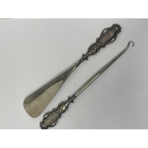 177 - A shoehorn and matching button hook, with silver mounts, cased, and a set of six coffee spoons, case... 