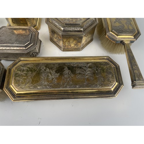 173 - An 18th century style silver gilt dressing table set, with chinoiserie style decoration, comprising ... 