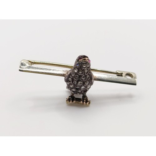 430 - A diamond and red stone bird bar brooch