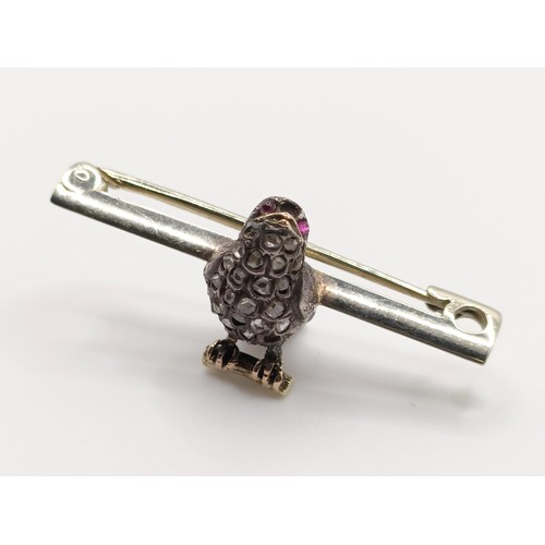 430 - A diamond and red stone bird bar brooch