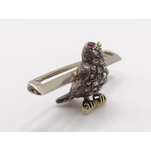 430 - A diamond and red stone bird bar brooch