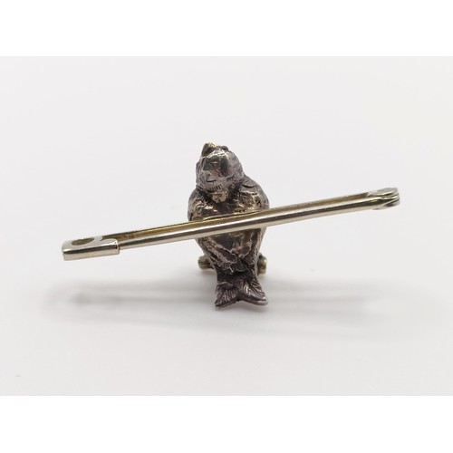 430 - A diamond and red stone bird bar brooch