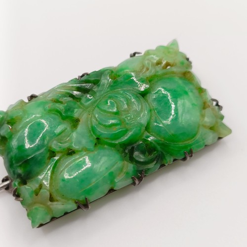 467 - A 1920s carved jadeite plaque brooch, decorated flowers