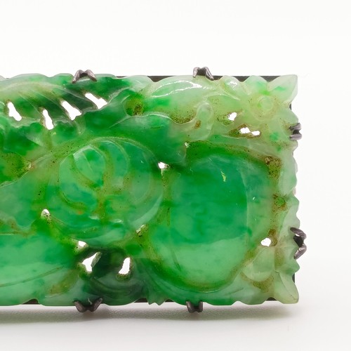 467 - A 1920s carved jadeite plaque brooch, decorated flowers