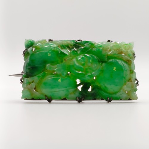 467 - A 1920s carved jadeite plaque brooch, decorated flowers