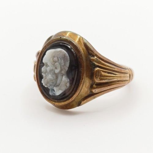 443 - A yellow coloured metal and cameo ring, carved a portrait of a bearded man, ring size O