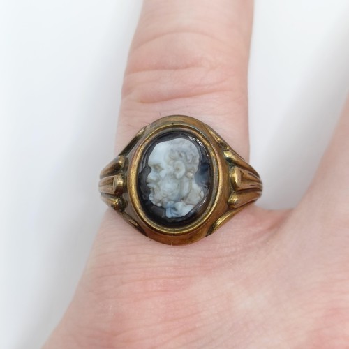 443 - A yellow coloured metal and cameo ring, carved a portrait of a bearded man, ring size O