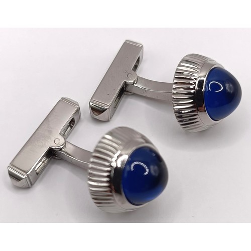 623 - A pair of Cartier silver coloured metal and blue glass cufflinks, boxed