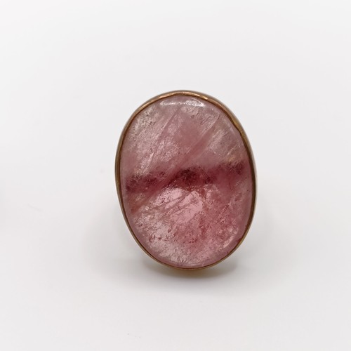 477 - A pink quartz plaque ring, ring size K, and a 10ct gold and green stone ring, ring size J (2)