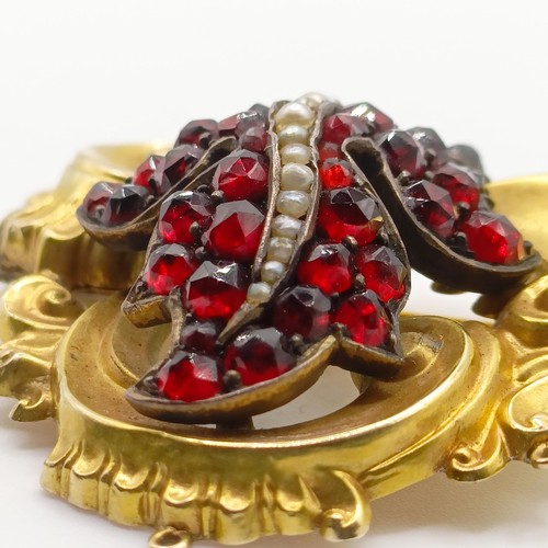 468 - An early 20th century yellow coloured metal, garnet and seed pearl brooch