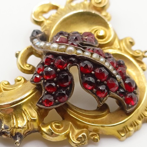 468 - An early 20th century yellow coloured metal, garnet and seed pearl brooch