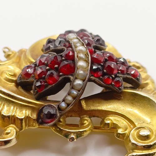 468 - An early 20th century yellow coloured metal, garnet and seed pearl brooch