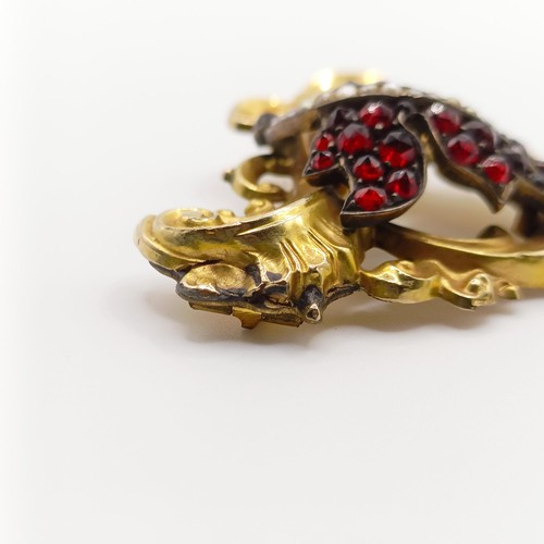 468 - An early 20th century yellow coloured metal, garnet and seed pearl brooch