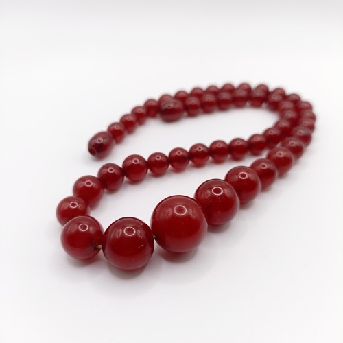 470 - A red amber bead necklace, 24.1 g