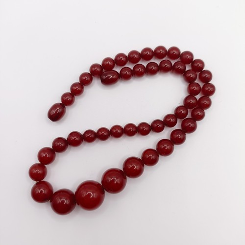 470 - A red amber bead necklace, 24.1 g