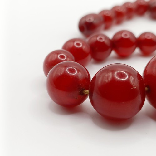 470 - A red amber bead necklace, 24.1 g