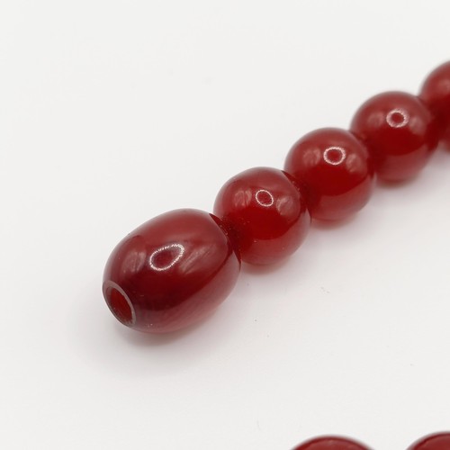 470 - A red amber bead necklace, 24.1 g