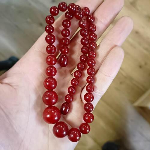 470 - A red amber bead necklace, 24.1 g