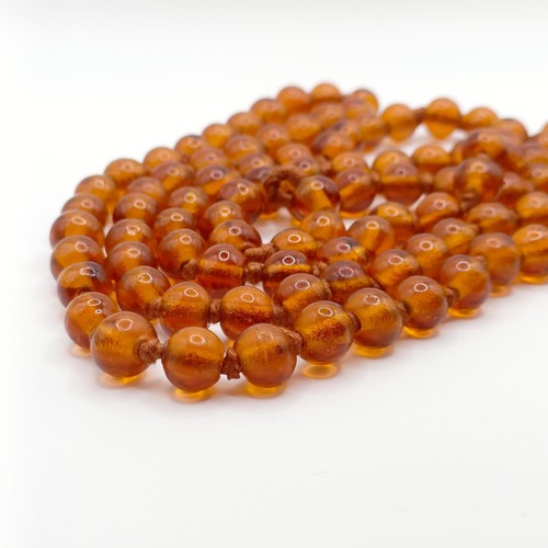 466 - An amber coloured glass bead necklace