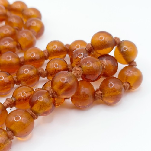 466 - An amber coloured glass bead necklace