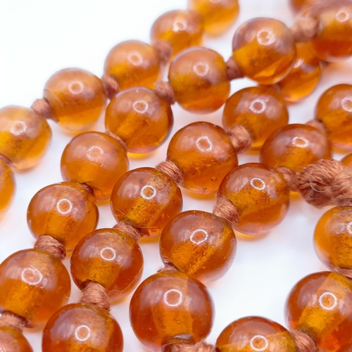 466 - An amber coloured glass bead necklace