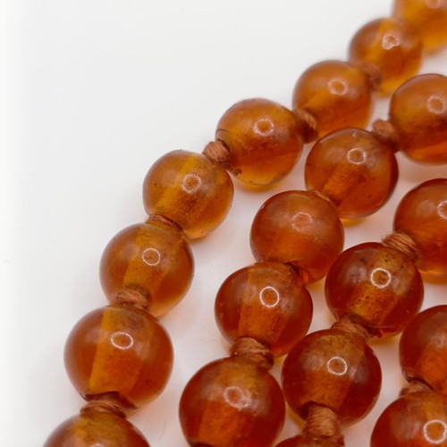 466 - An amber coloured glass bead necklace