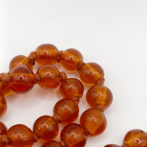 466 - An amber coloured glass bead necklace