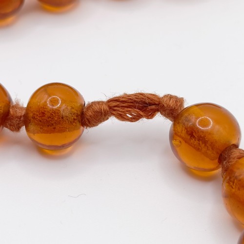 466 - An amber coloured glass bead necklace