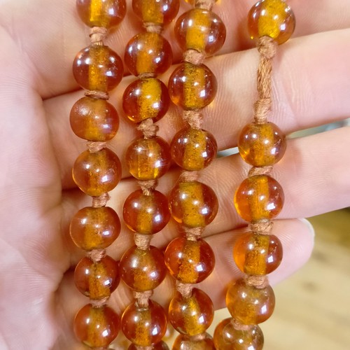 466 - An amber coloured glass bead necklace