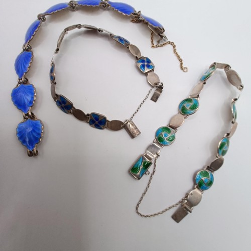 629 - A Danish silver coloured metal and blue enamel bracelet, and two others similar (3)