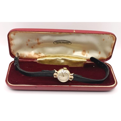 584 - A ladies 9ct gold Omega wristwatch, with a leather strap, in a vintage jewellery box