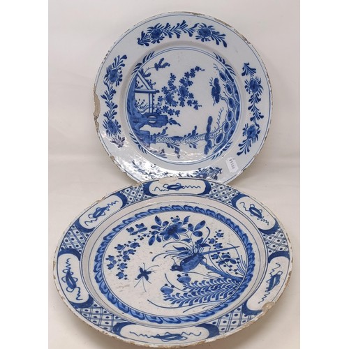 1101 - A blue and white Delft plate, decorated birds and flowers, 35 cm diameter, and another, decorated in...