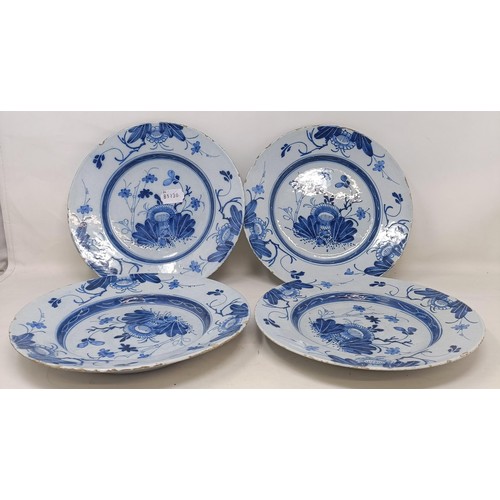 1104 - A set of four blue and white Delft plates, decorated flowers, 23 cm diameter