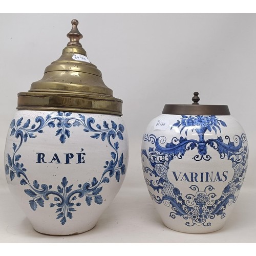 1106 - A Delft blue and white apothecary jar, Rape, with a brass lid, 34 cm high, and another, Varinas, wit... 