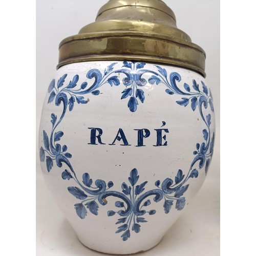 1106 - A Delft blue and white apothecary jar, Rape, with a brass lid, 34 cm high, and another, Varinas, wit...