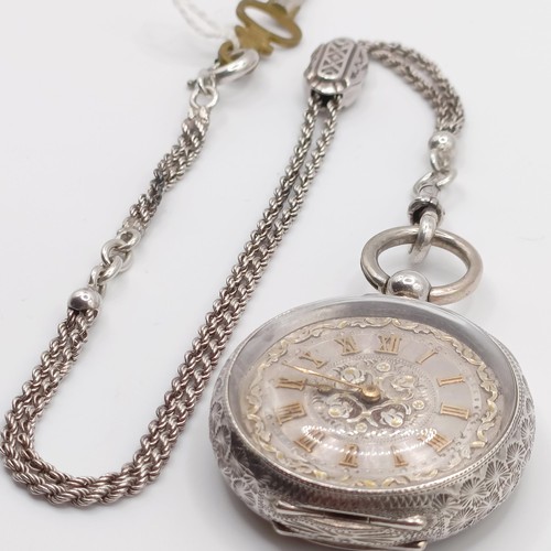 611 - A ladies  silver open face pocket watch, the movement signed J Dowell & Co, on a chain