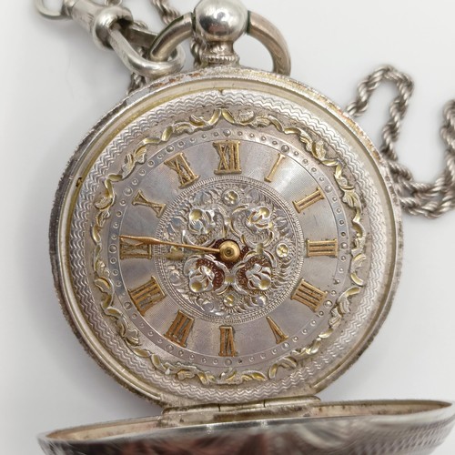 611 - A ladies  silver open face pocket watch, the movement signed J Dowell & Co, on a chain