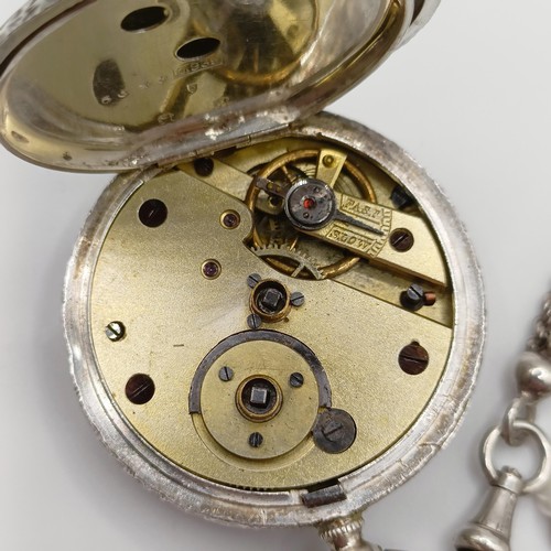 611 - A ladies  silver open face pocket watch, the movement signed J Dowell & Co, on a chain