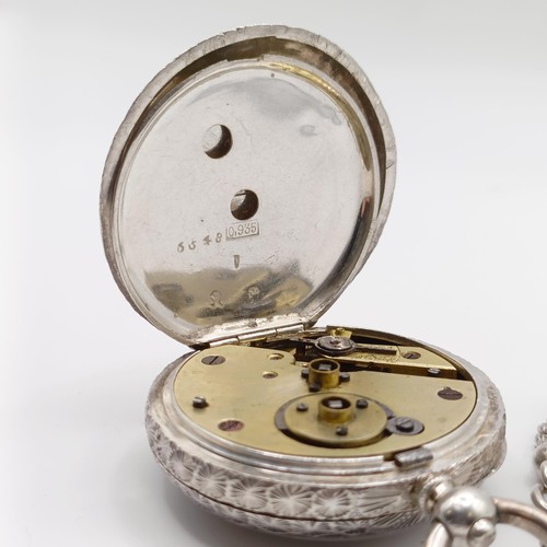 611 - A ladies  silver open face pocket watch, the movement signed J Dowell & Co, on a chain