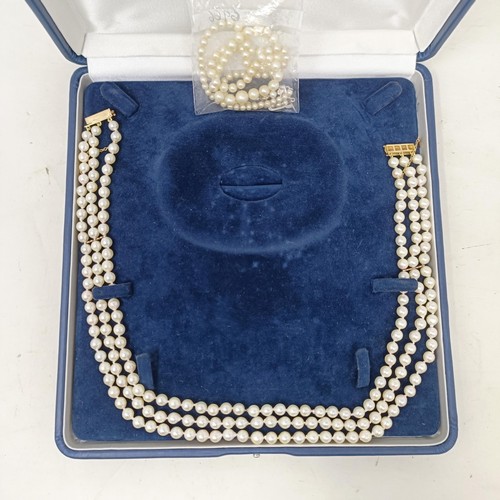 531 - A pearl triple strand necklace, with a 9ct gold clasp, by Coleman Douglas, cased