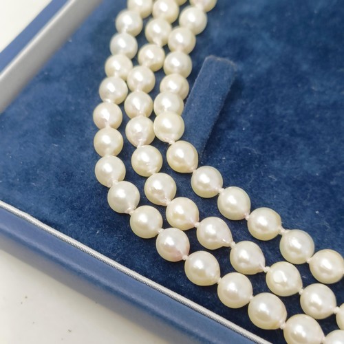 531 - A pearl triple strand necklace, with a 9ct gold clasp, by Coleman Douglas, cased