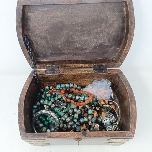 533 - A large brass bound wooden casket of semi-precious beads, including rose quartz, jade, malachite and... 