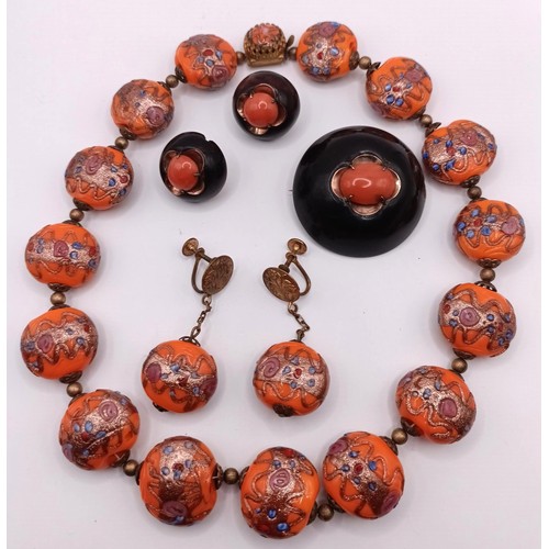 538 - An orange bead necklace, a matching pair of earrings, a coral brooch, and a matching pair of earring... 