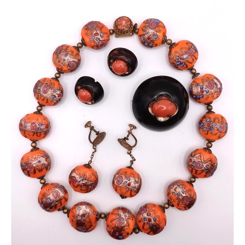 538 - An orange bead necklace, a matching pair of earrings, a coral brooch, and a matching pair of earring... 